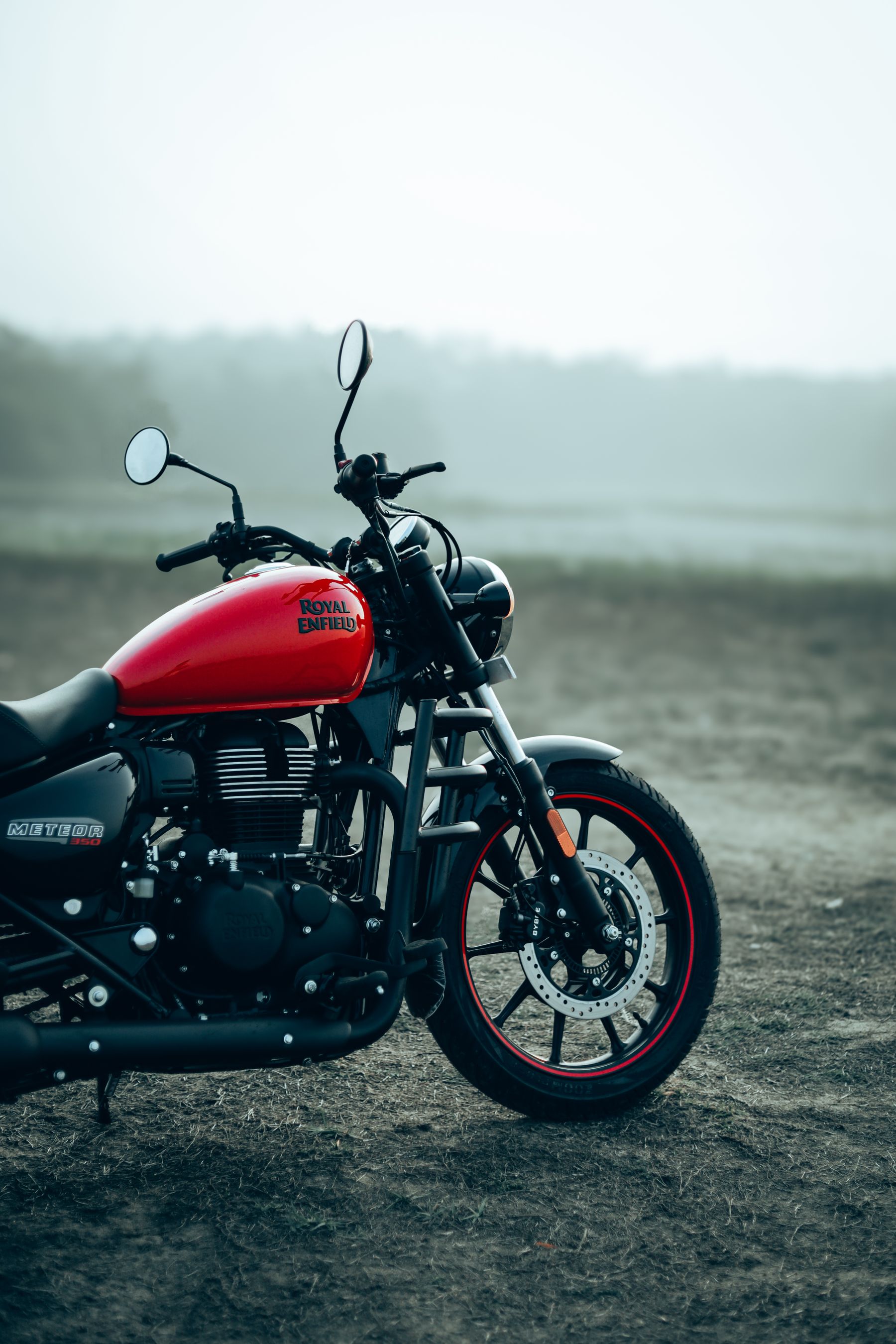 Red Royal Enfield Meteor 350 in morning mist