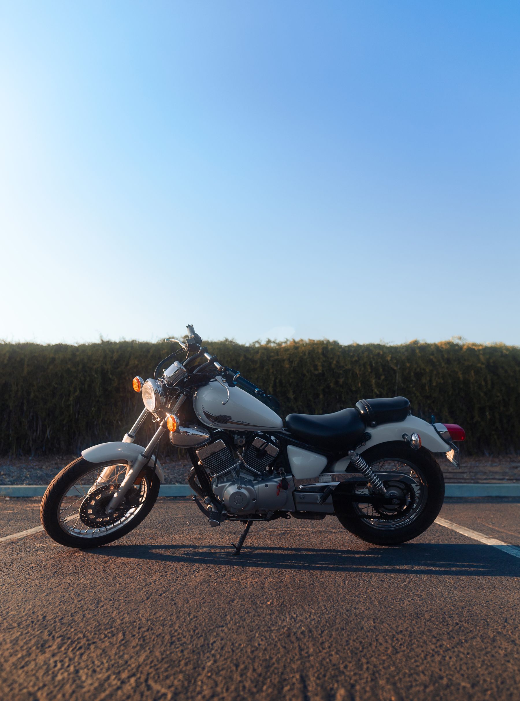 White Yamaha Virago 250 cruiser in evening light